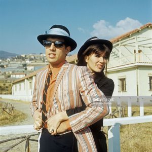 Italian singer Adriano Celentano and his wife Claudia Mori posing together in the street at the 18th Sanremo Music Festival. Sanremo, February 1968
