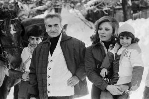 25 Feb 1975, St.-Moritz, Switzerland --- From left to right: Reza II Pahlavi, the Crown Prince, their father, the Shah of Iran Mohammed Reza Shah Pahlavi, his wife and mother HIM Farah Pahlavi Empress (or Shahbanu) of Iran, holding their youngest daughter, Leila Pahlavi during a winter vacation. --- Image by © James Andanson/Sygma/Corbis