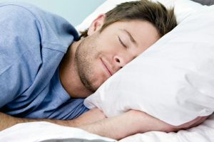 Man comfortably sleeping in his bed