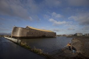 Johan Huibers, bottom right, poses, after being asked by a photographer to go outside, with a stuffed tiger in front of the full scale replica of Noah’s Ark in Dordrecht, Netherlands, Monday Dec. 10, 2012. The Ark has opened its doors in the Netherlands after receiving permission to receive up to 3,000 visitors per day. For those who don’t know or remember the Biblical story, God ordered Noah to build a boat massive enough to save animals and humanity while God destroyed the rest of the earth in an enormous flood. (AP Photo/Peter Dejong)