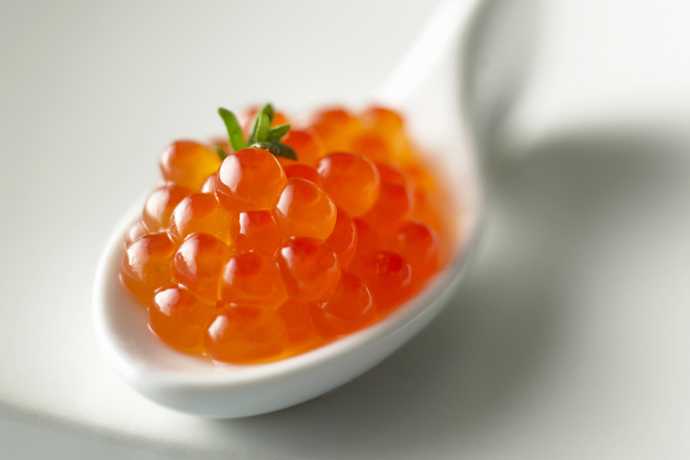 Salmon caviar on spoon, close-up