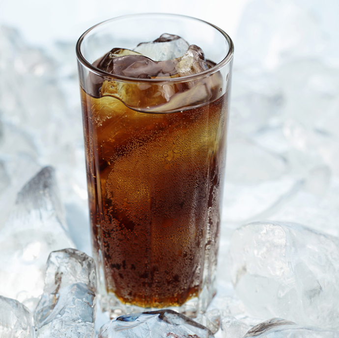 Glass of cola on crushed ice, close-up