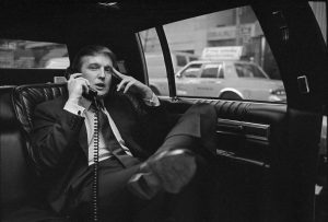 Donald Trump on the phone in his car after announcing plans for development of the west side of midtown Manhattan at the Hyatt Hotel on 42nd Street and Lexington Avenue, in New York, on Nov. 18, 1985.