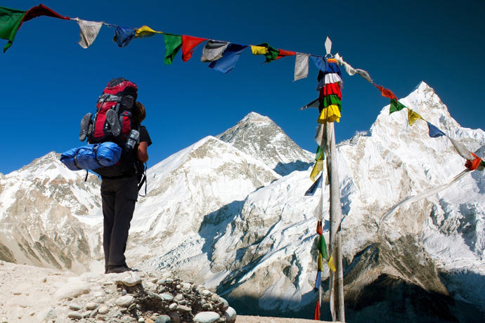 evening view of Everest with tourist and buddhist prayer flags from kala patthar and blue sky - way to Everest Base Camp - Nepal