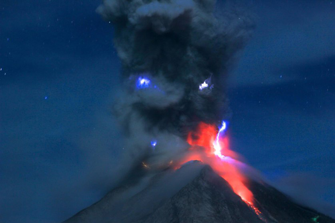 Hot lava and volcanic ashes rises from Mount Sinabung during an eruption in Karo, North Sumatra, Indonesia on Feb. 29, 2016.