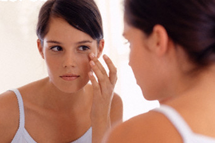 Teenage Girl Looking in Mirror --- Image by © Pixland/Corbis